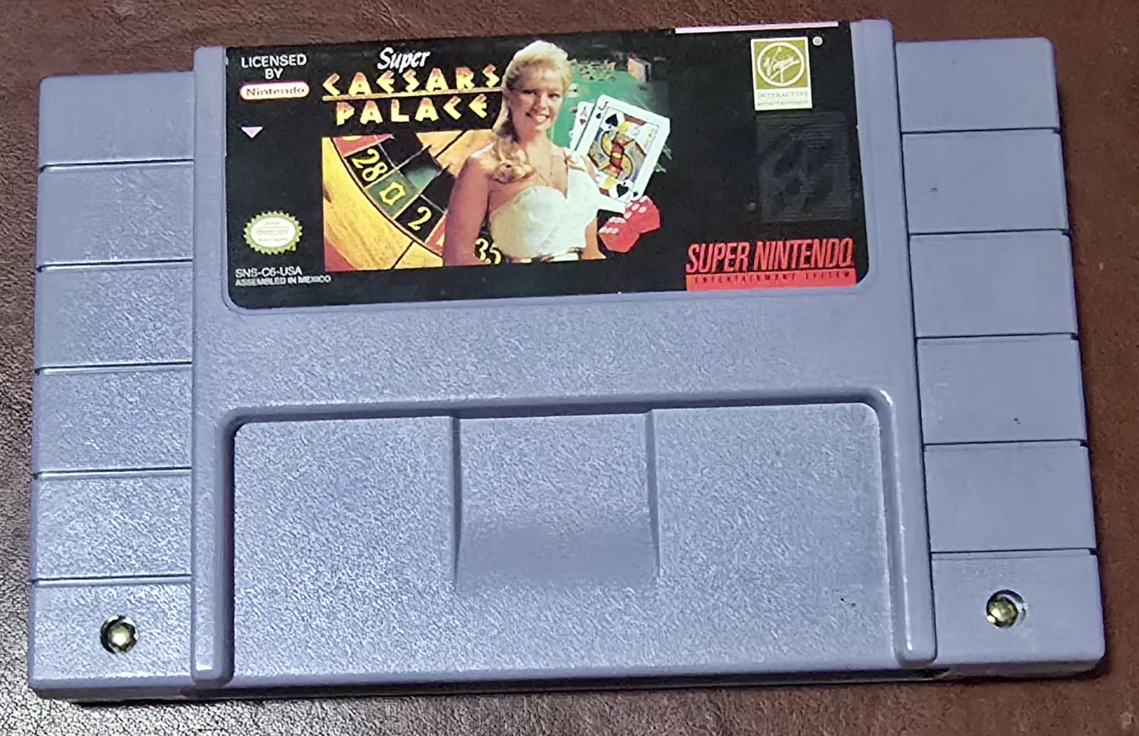 Front of an authentic Super Nintendo Super Caesars Palace cartridge by Virgin