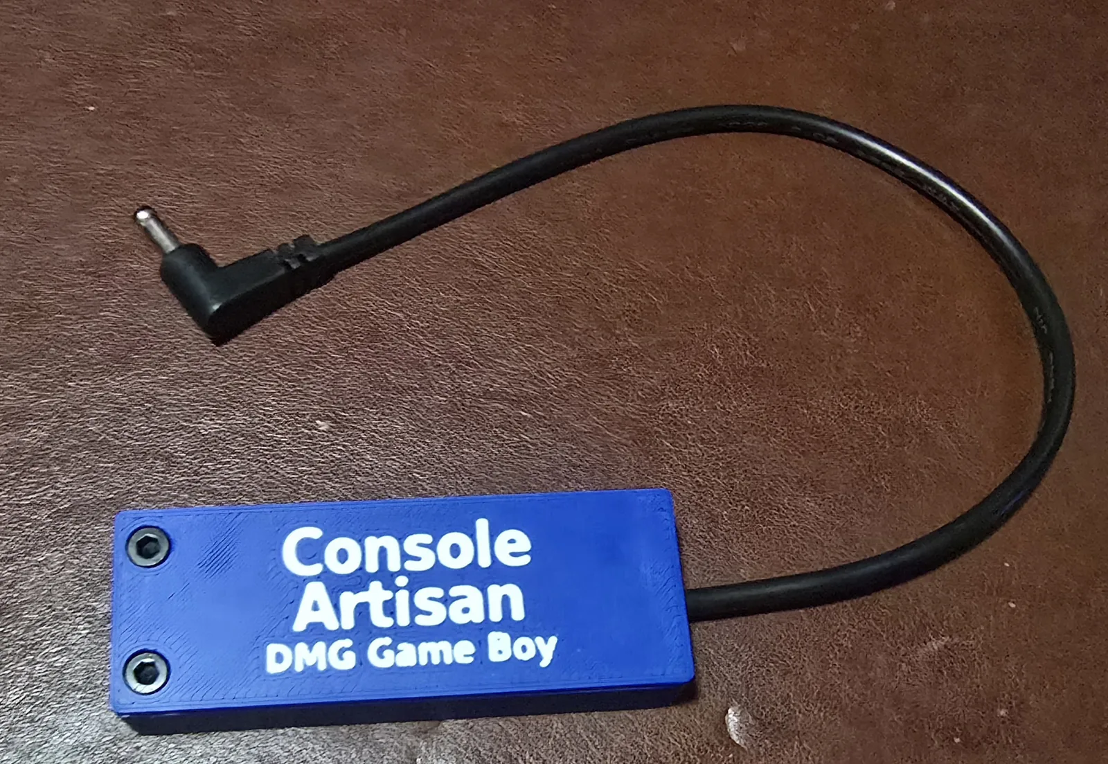 Front of the finished USB-C 6V Game Boy DMG power adapter, labeled Console Artisan DMG Game Boy, with its right-angle barrel cable