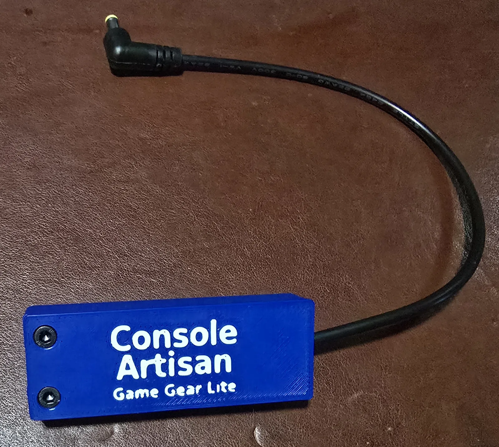 Front of the USB-C Game Gear Lite power adapter, labeled Console Artisan Game Gear Lite, with its right-angle barrel cable